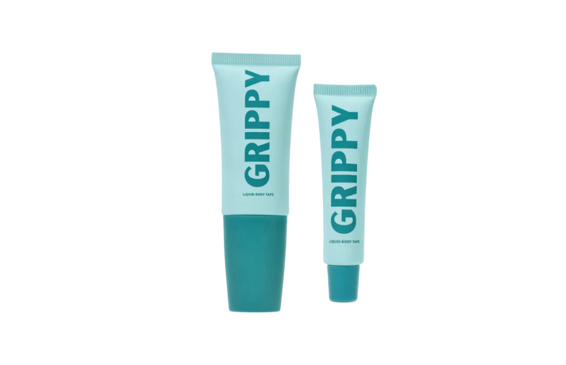 A tube of Grippy liquid body tape standing beside its carton.