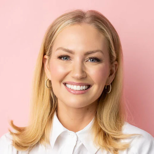 Portrait of Tucky founder Brooke Knaus, smiling in a white collared shirt against a pink background.