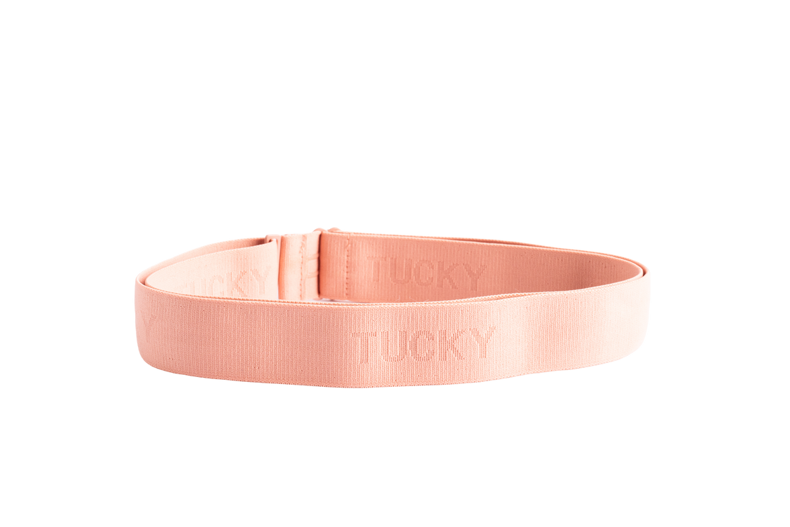 A blush pink elastic waistband loop embossed with the Tucky name.