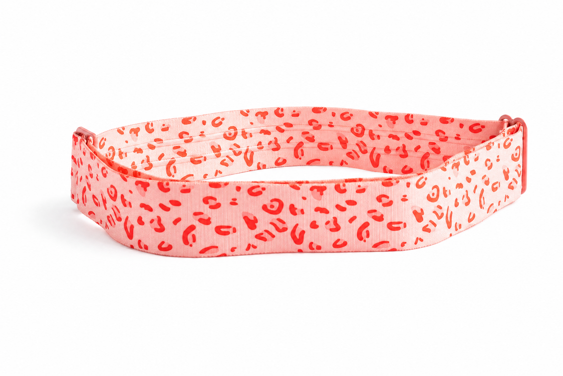 Pink leopard-print Tucky tucking belt on a white background.